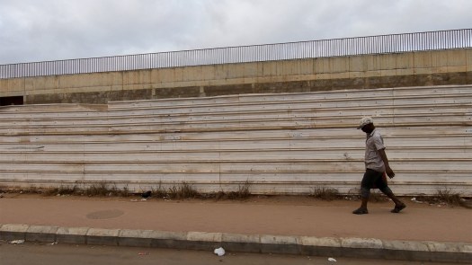 Like everybody in Sambizanga, this man carries a canister of water. The business of water is massive: homes in the asphalt areas are forced to have their own water pumps and generators for electricity.